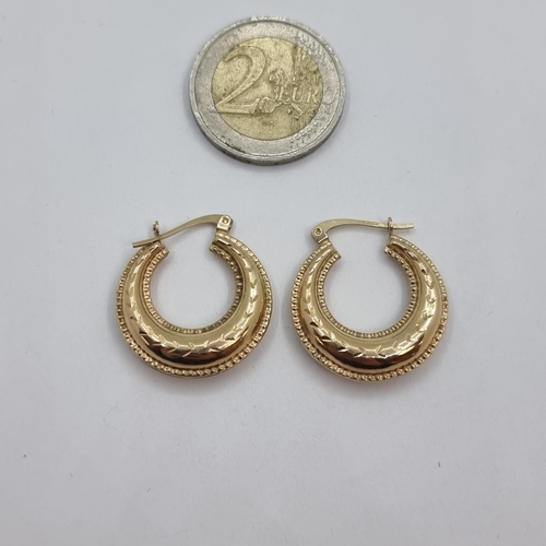 4 - A pair of  large 9K gold earrings (stamped 375) with stamped decoration, suitable for pierced ears. ... 