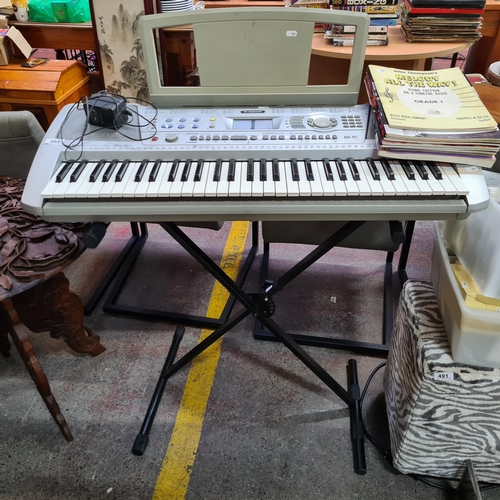 A Yamaha PSR-290 full size electronic keyboard on adjustable stand 