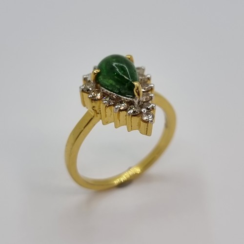 369 - Stat Lot : A gorgeous 14k gold ring set with a Pear Cabochon Tsavorite Garnet. Surrounded by 16 natu... 