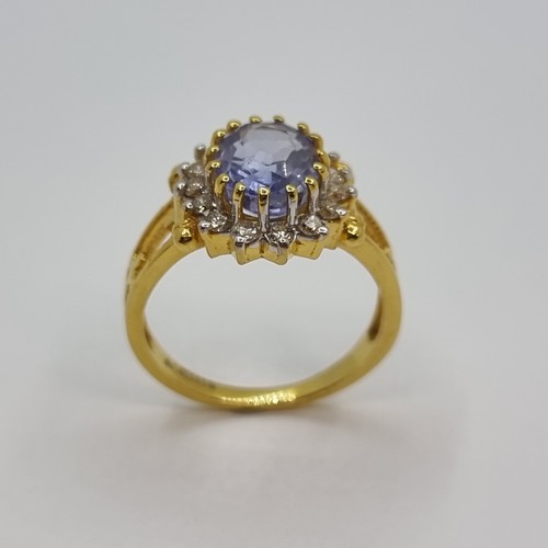 370 - A beautiful 14k Gold Ring (stamped) with a large oval cut natural Sapphire 3.6cts . Surrounded by 15... 