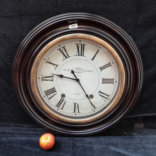 A large hanging wall clock by "Dublin Clockwork" with a circular frame