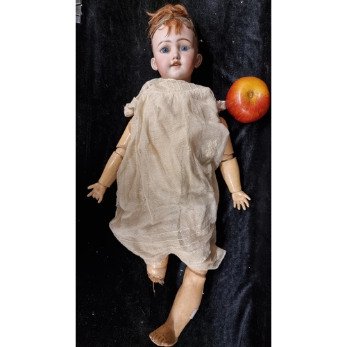105 - A 19th century doll with a beautiful hand painted porcelain head with realistic features, blue glass... 