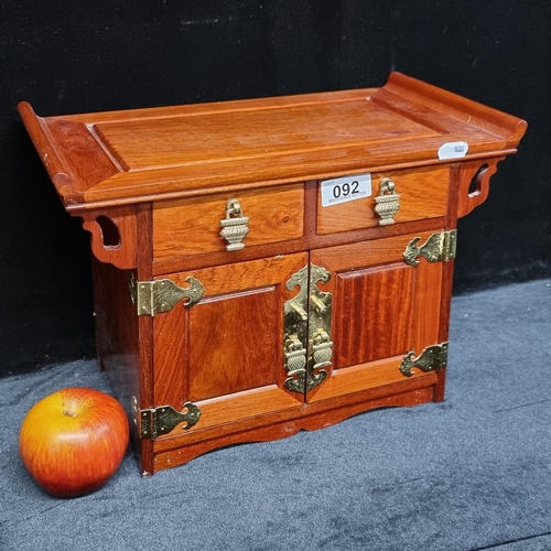 92 - A Chinese Pagoda rosewood jewellery chest with five fabric lined drawers, featuring brass drop handl... 