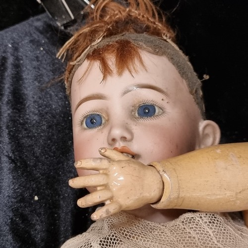 105 - A 19th century doll with a beautiful hand painted porcelain head with realistic features, blue glass... 