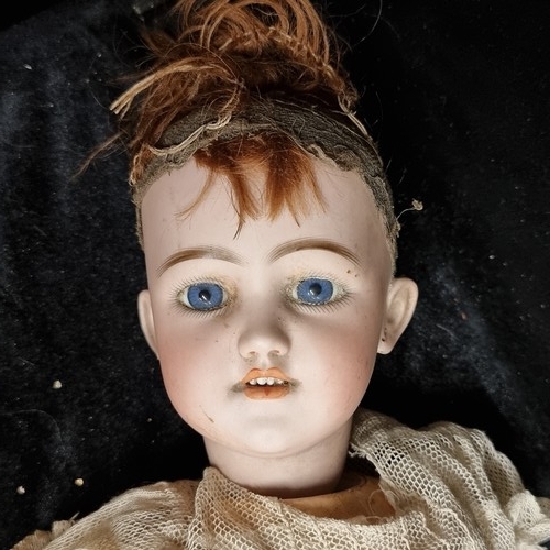 105 - A 19th century doll with a beautiful hand painted porcelain head with realistic features, blue glass... 