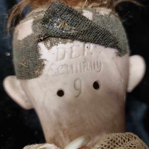 105 - A 19th century doll with a beautiful hand painted porcelain head with realistic features, blue glass... 