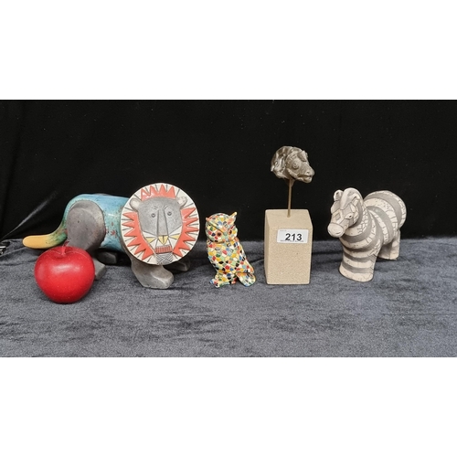 213 - Four figurines including two hand made South African pieces of a lion and zebra and a bust from the ... 