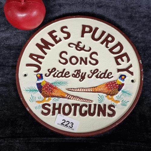 223 - A hand painted round cast metal advertisement piece for James Purdey & Sons Shotguns featuring two p... 