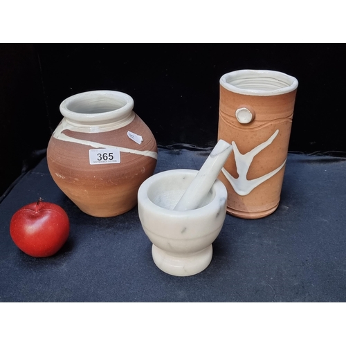 365 - Three kitchen items, including a good quality, heavy marble pestle and mortar and two terracotta jar... 