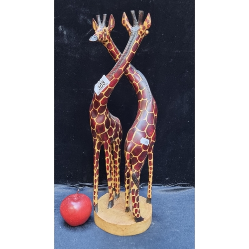 368 - A tall decorative carved wooden pair of Giraffes, hand-painted in realistic colours. In good conditi... 