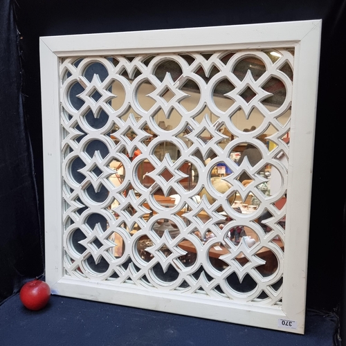370 - A mirror in a carved wooden trellis frame. Reminiscent of Moroccan carving work. Heavy very good qua... 
