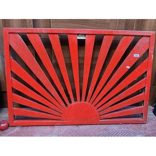 375 - Two vintage wooden garden wooden wall decoration in a striking red with a hand crafted sun ray desig... 