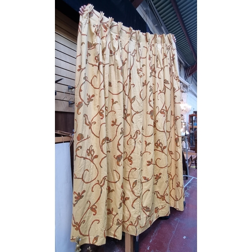 378 - A heavy pair of lined curtains in magnolia with lovely foliate design in burnt orange, with a pair o... 