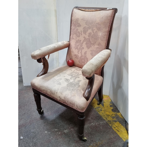 399 - A heavy 19th century library chair with attractive scroll armrests and curved backrest detail. With ... 
