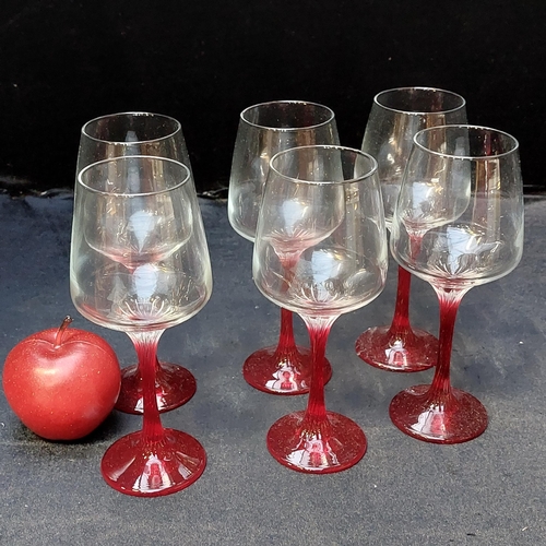 413 - A set of 6 wine glasses by ''The Original Symphony'' (SY30415) with striking ruby glass stems. As ne... 