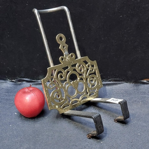 414 - A sliding fireplace trivet with a beautiful pierced brass sliding base.