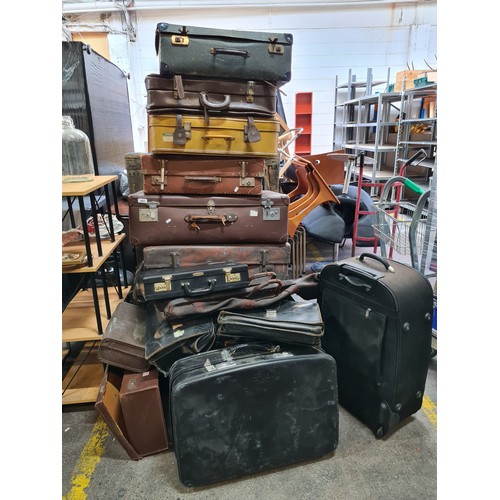 402 - A collection of 20 vintage suitcases, carry cases and briefcases with some early 20th century exampl... 