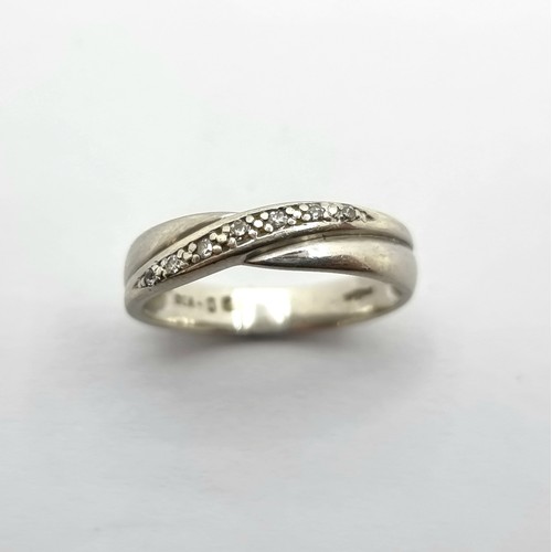 222 - White 9ct gold band with diamond cross over. 2.3g size N