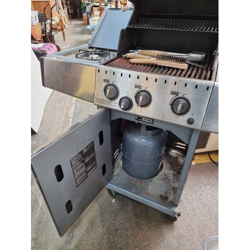 401 - A Broil King gas powered barbecue with storage underneath, gas ring on the left. space either side f... 