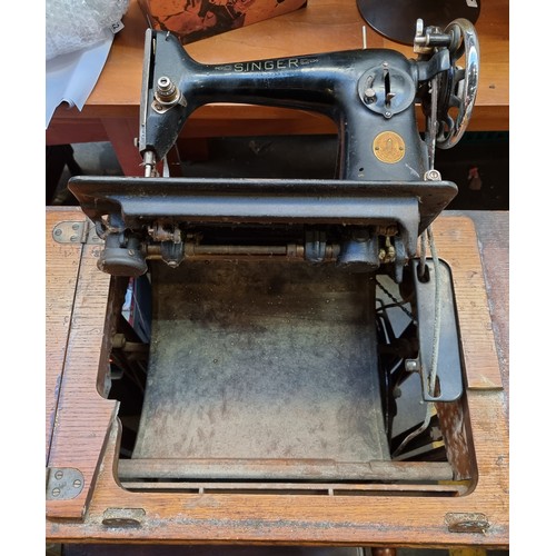 424 - An antique Singer sewing machine built into a gumwood table with pedal to work antique sewing machin... 
