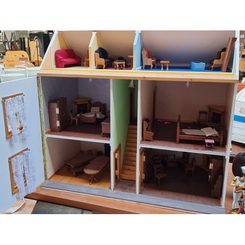 417 - A beautiful wooden doll's house painted in shades of cream and terracotta. The home includes, a hing... 