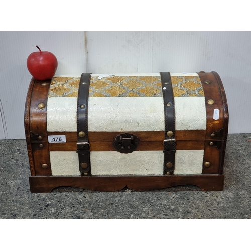 476 - A decorative hardwood chest with leather straps, bronze toned latch and a decorative damask panel.