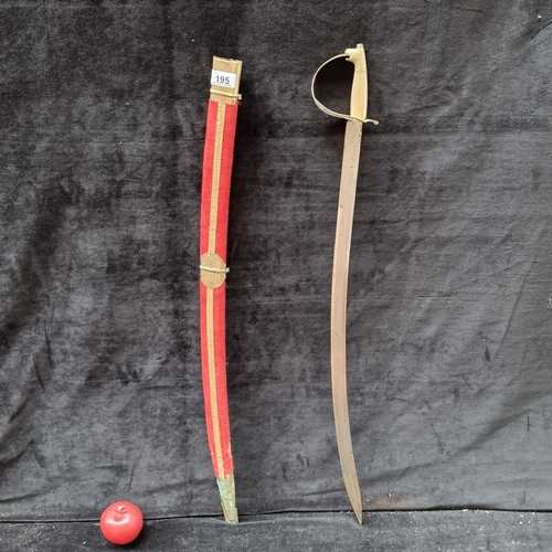 195 - A vintage Indian Sikh offer's sword with a red velvet scabbard and a heavy brass hilt with a tiger h... 