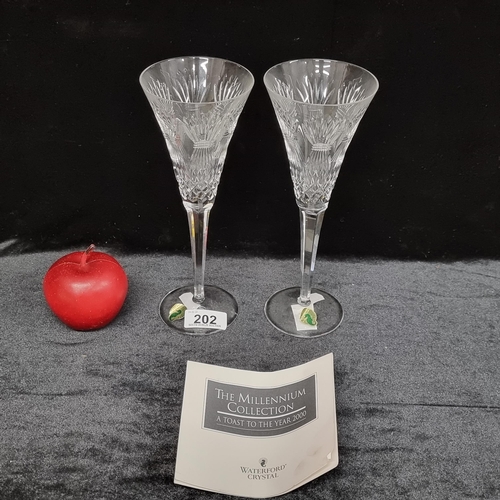 202 - A pair of toasting champagne flutes by Waterford Crystal in the prosperity pattern for the Millenniu... 