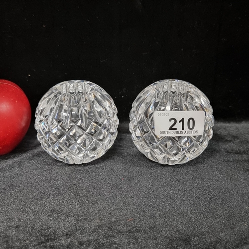 210 - A pair of Waterford Crystal candle holders, both matching in a bauble shape with diamond quilt cut p... 