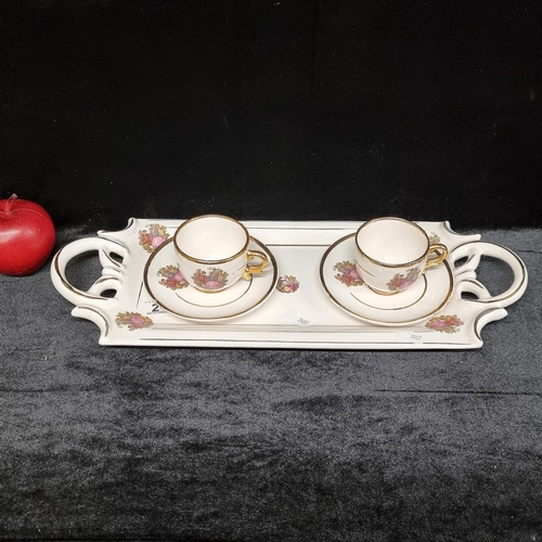 218 - A unusual two piece china set with accompanying tray, in a traditional figural and gilt transferware... 