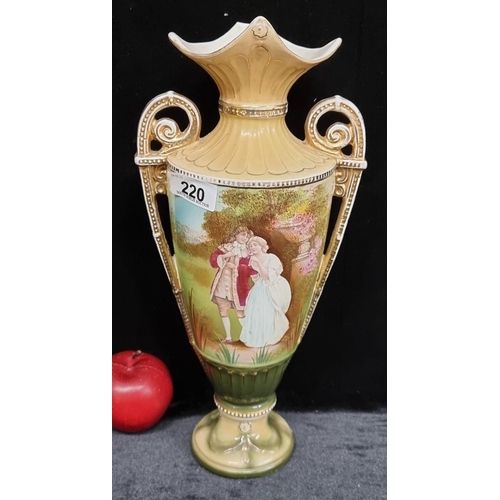 220 - A decorative scroll handled urn with a brightly painted romantic courting scene, gilt detail and a f... 