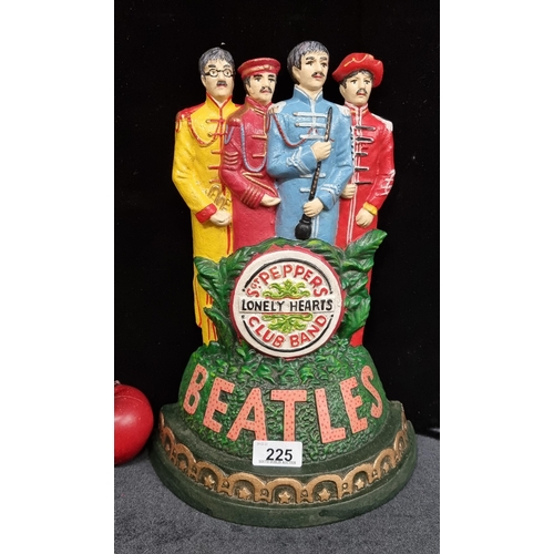 225 - A very heavy cast metal figural statue of The Beatles in their distinctive bright album regalia of t... 