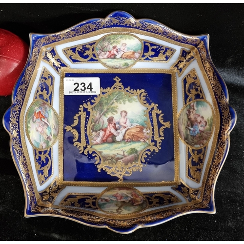 234 - An ornate porcelain dish with cobalt blue glaze, gilt detail and courting scenes. Stamped with ''Sèv... 