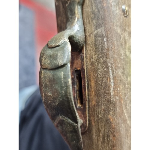 196 - A heavy wooden and brass Flintlock Blunderbuss with a short, large caliber barrel which is flared at... 