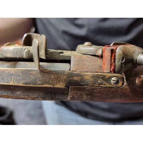 196 - A heavy wooden and brass Flintlock Blunderbuss with a short, large caliber barrel which is flared at... 