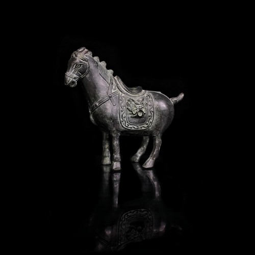 555 - An early 20th century Chinese hand engraved cast heavy bronze horse statuette with lion head saddle.... 