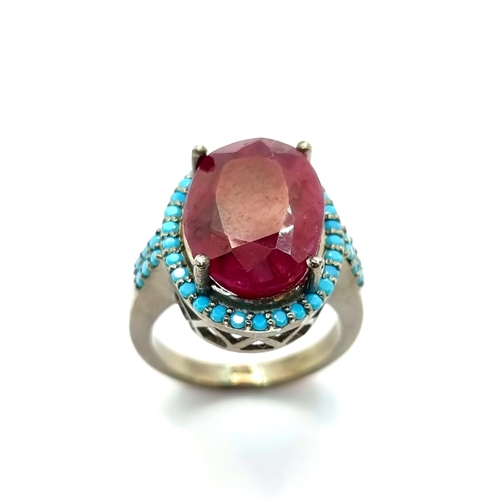 21 - A very pretty facet cut natural ruby stone ring with turquoise surround. Ring size N, weight 9.75g. ... 