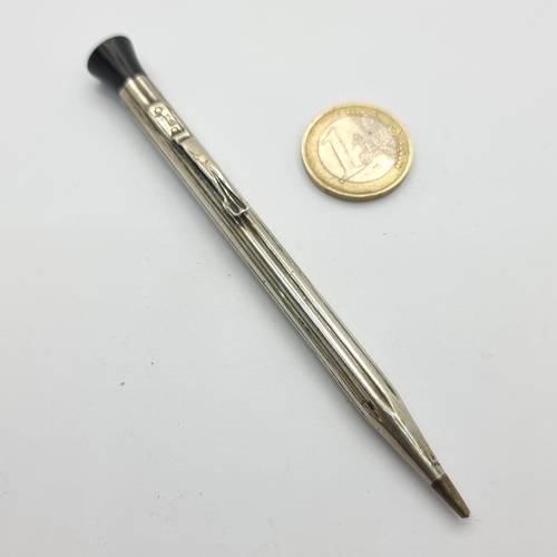 33 - A propelling pencil, in Britannia 935 silver. Total weight 11.9g.
