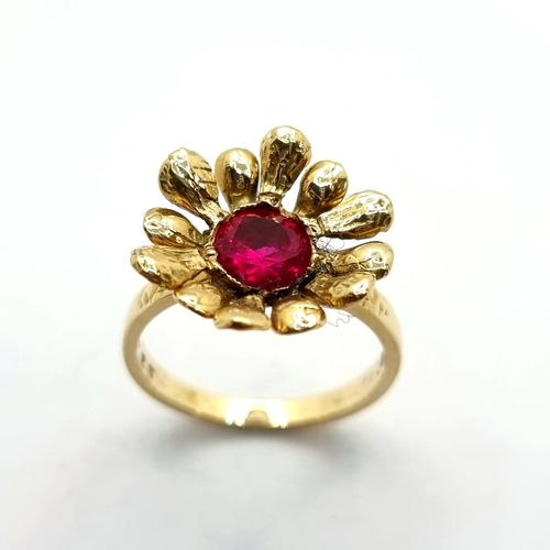 43 - An attractive 9K gold ruby stone floral set ring. Ring size O, weight 3.55g.