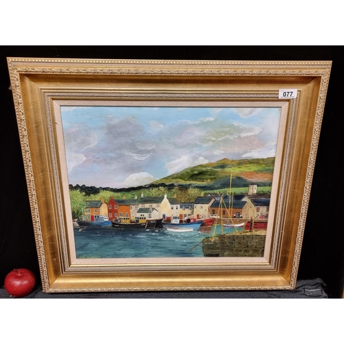 77 - A large original oil on board painting featuring a quaint looking Dingle town with many boats set ag... 