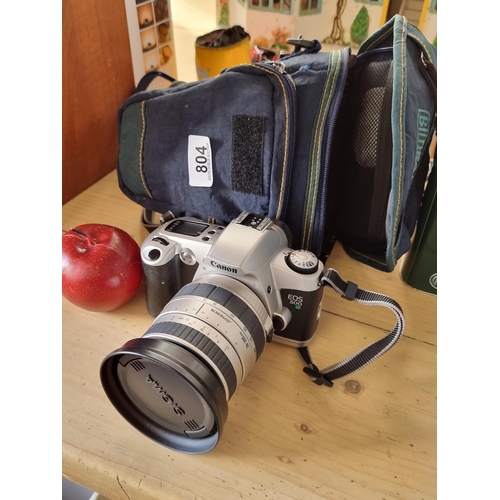 804 - A Canon EOS 500 N Manual SLR film camera in a shaped SLR carry case. with Sigma 28-200mm lens