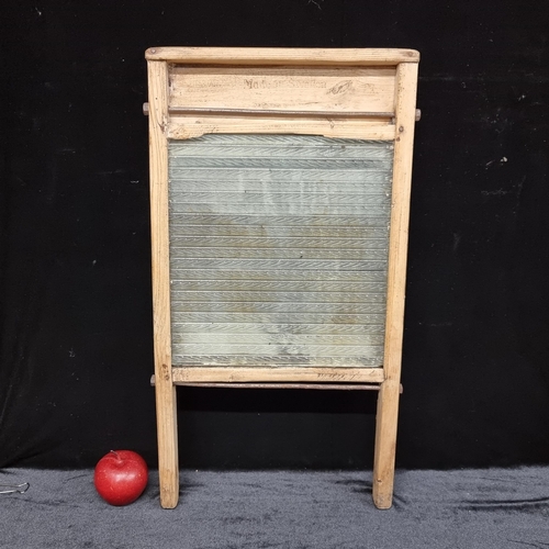 85 - An antique washboard with glass textured front for thorough cleaning. Made in Sweden for Irish use.