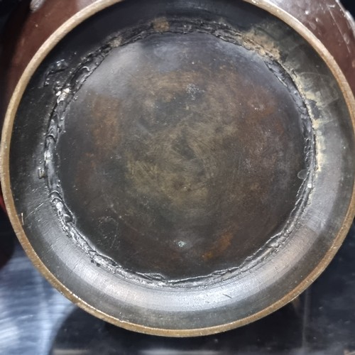 521 - A elegant Japanese heavy bronze urn on a high rim foot rim with swallow motifs in relief on the exte... 