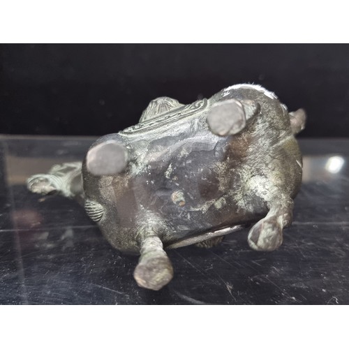 555 - An early 20th century Chinese hand engraved cast heavy bronze horse statuette with lion head saddle.... 