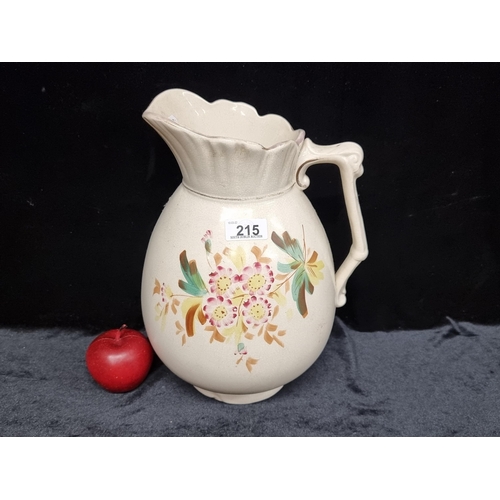 215 - A large Antique ceramic pitcher jug with hand painted floral motif.