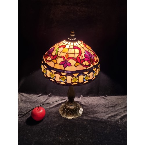 222 - A large beautiful table lamp with tiffany style shade in stained glass colours of mauve , amber and ... 