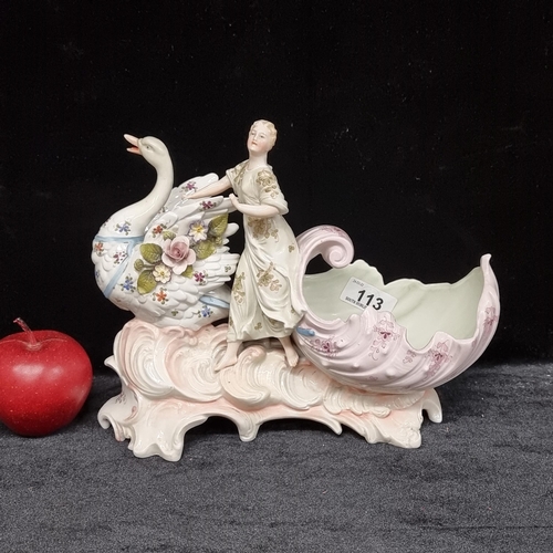 113 - A highly ornate antique porcelain sculptural piece depicting an elegant lady riding a swan carriage,... 