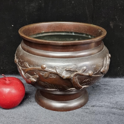 224 - An antique Japanese heavy bronze urn on a high rim foot rim with swallow motifs in relief on the ext... 