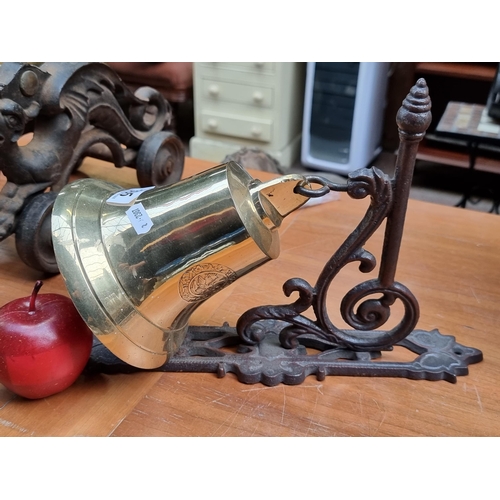 395 - A vintage wall mounting door bell with a very heavy polished brass bell embossed 