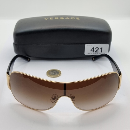 421 - A good pair of original  Versace, made in Italy, wraparound style sunglasses. Lenses in good order. ... 